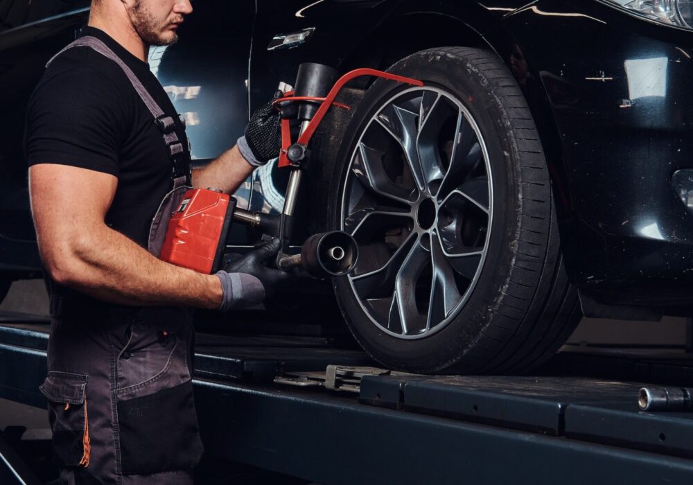 Man is doing balancing for tyres